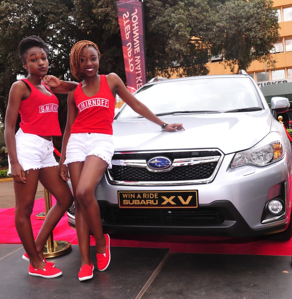 Models Melisa Brandy and Esther Achieng pose with the Subaru X5, the rand prize of the promotion.