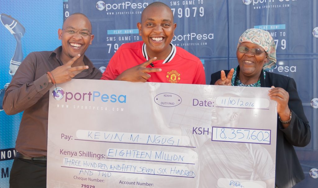 SportPesa jackpot co-winner Kevin Ngugi (centre) is all smiles.